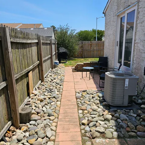 a view of a patio with wooden fence
