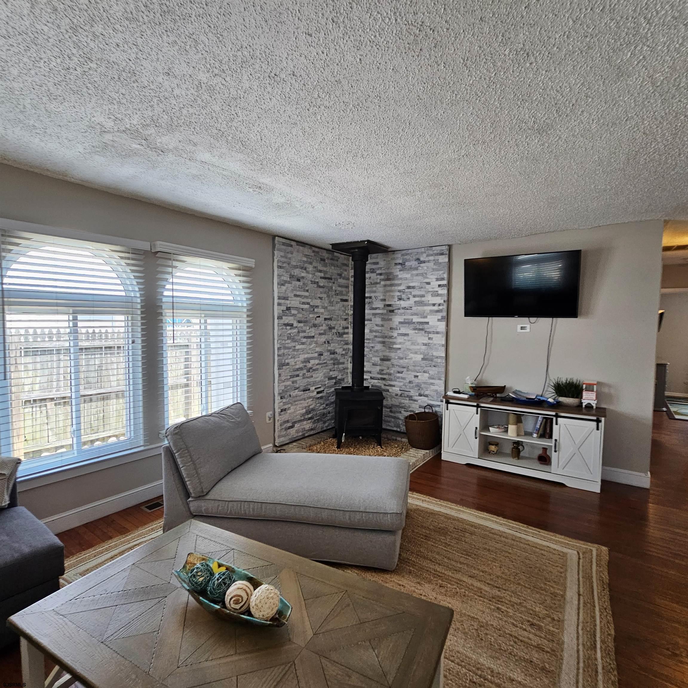 518 Casa Drive, Unit SUMMER RENTAL Brigantine, NJ 08203 - Photo 6 of 19 a living room with furniture and a flat screen tv