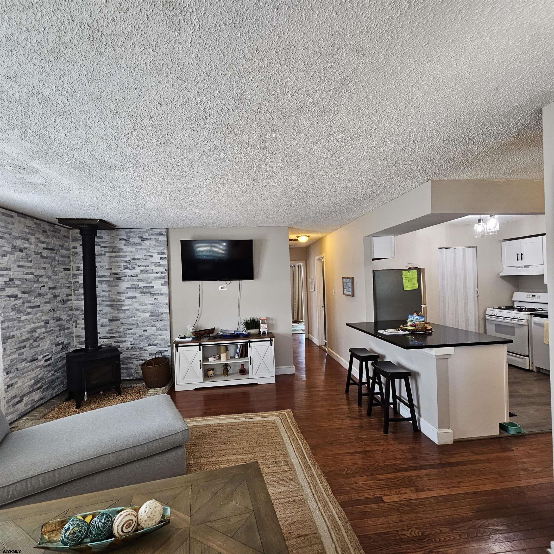 518 Casa Drive, Unit SUMMER RENTAL Brigantine, NJ 08203 - Photo 7 of 19 a living room with furniture and a flat screen tv