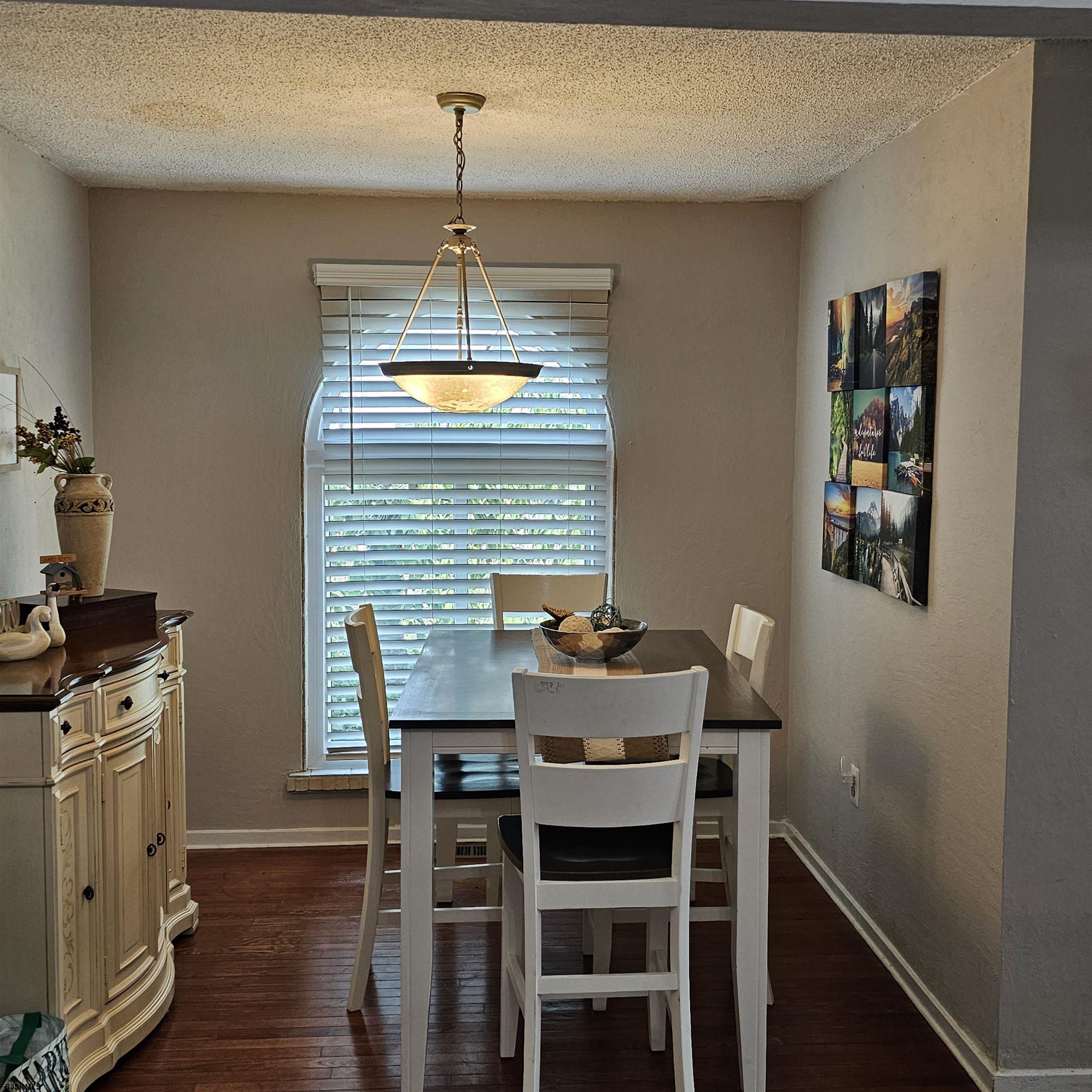 518 Casa Drive, Unit SUMMER RENTAL Brigantine, NJ 08203 - Photo 10 of 19 a dining room with furniture and chandelier