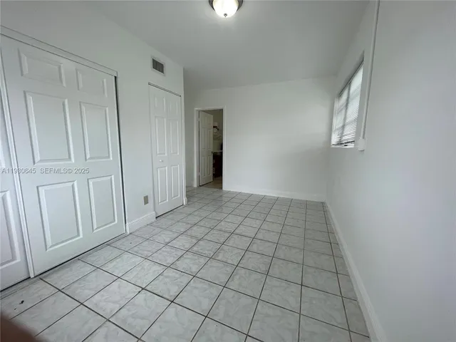 a view of an empty room and wooden floor