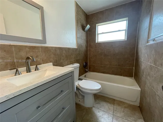 a bathroom with a sink a toilet and bathtub