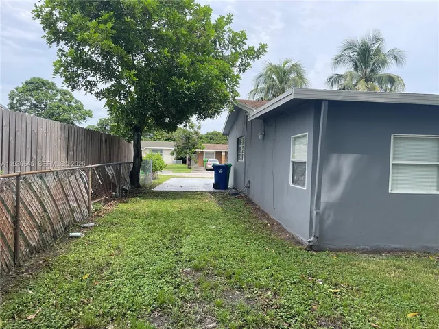 a front view of house with yard and trees