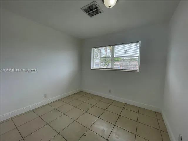a front view of house with yard and palm tree