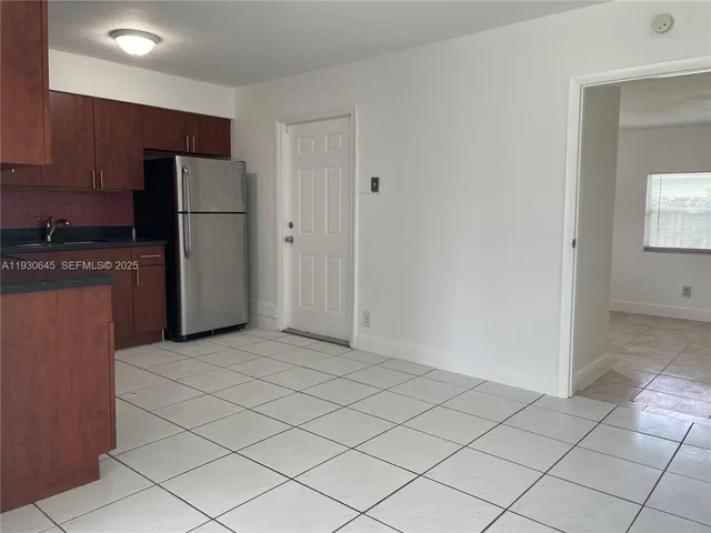 a kitchen with a refrigerator and cabinets