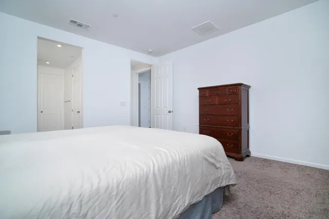 a bedroom with a bed and a dresser