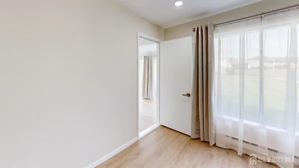 a view of an empty room and wooden floor