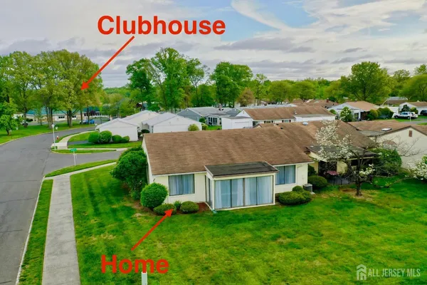 a view of yard from deck with patio