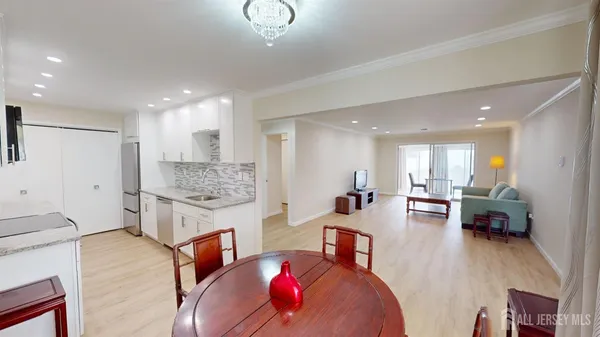 a living room with furniture and kitchen view