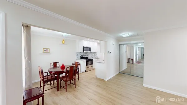 a view of a dining room with furniture and wooden floor