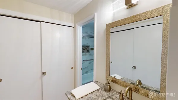 a bathroom with a shower and a sink