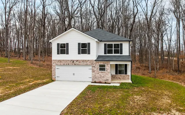 a front view of a house with a yard and garage