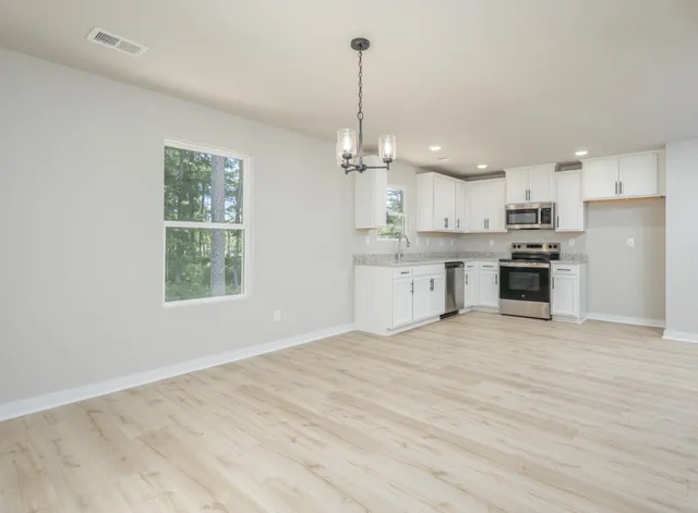 a view of a kitchen with microwave and cabinets