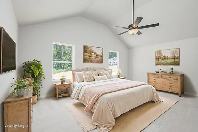 a bedroom with a bed and a potted plant