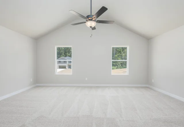 an empty room with a window and a ceiling fan