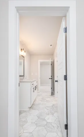 a bathroom with a granite countertop sink mirror and shower