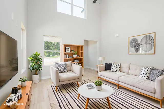 a living room with furniture potted plant and a window
