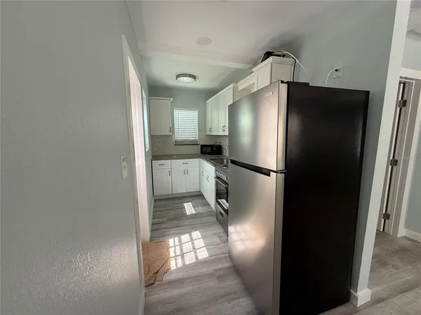a kitchen with stainless steel appliances a refrigerator and a sink