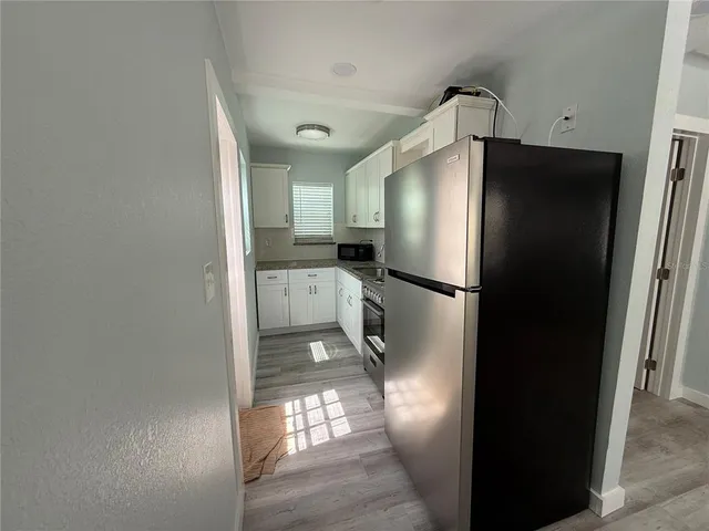 a kitchen with stainless steel appliances a refrigerator and a sink