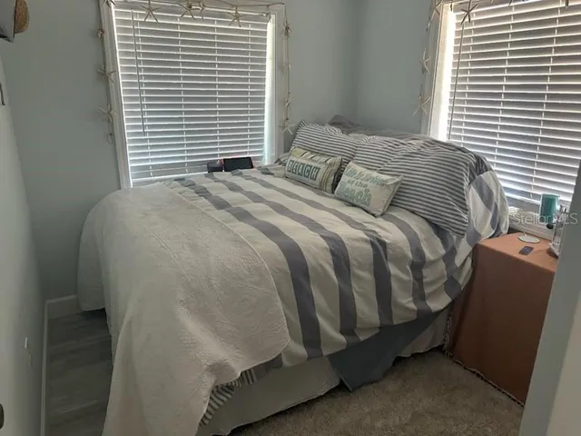 a bedroom with a bed and window