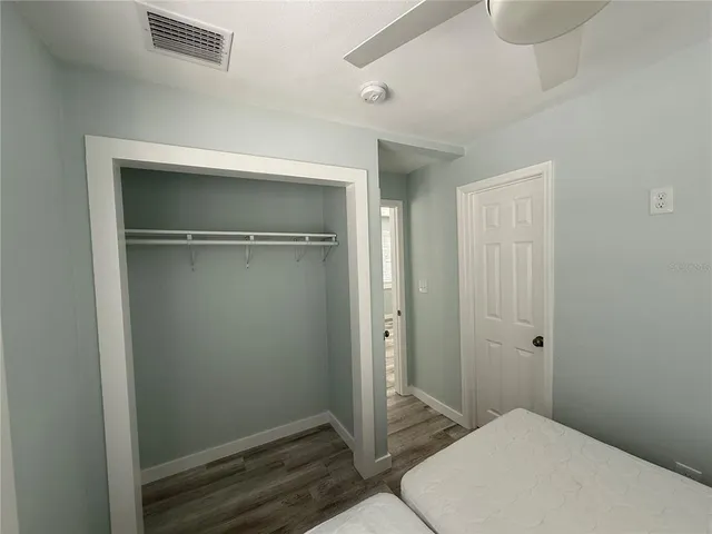 a bedroom with a bed and a dresser