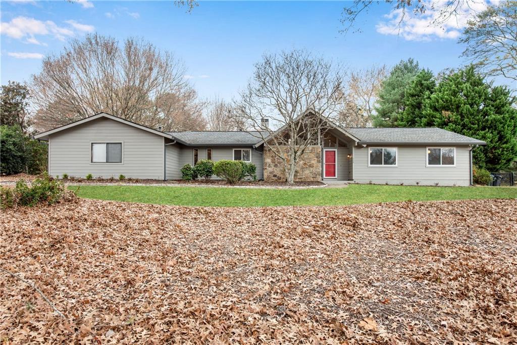 770 Rounsaville Road Roswell, GA 30076 - Photo 1 of 1 a house with green field in front of it