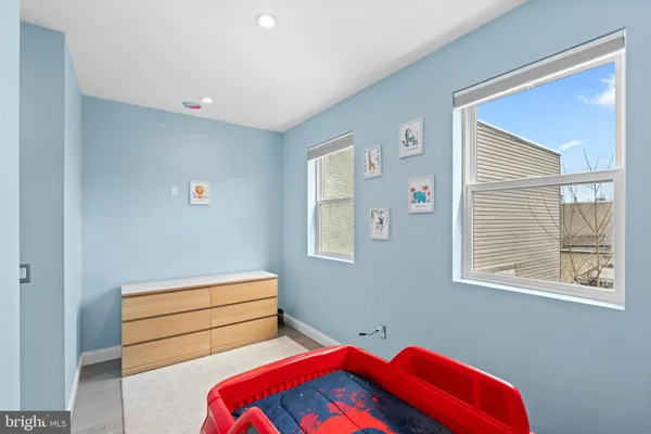 a room with two bed and a window