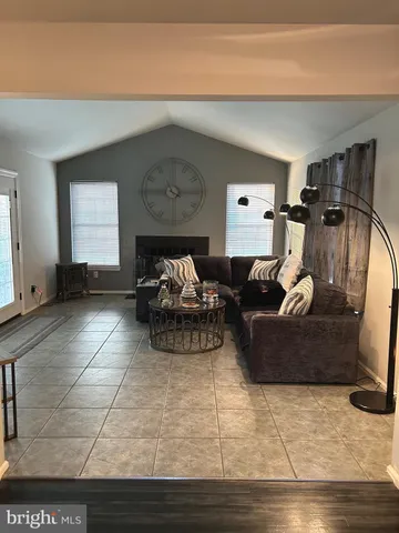 a view of a livingroom with furniture and a window