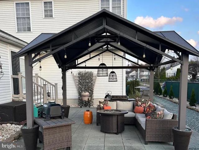 a view of a backyard with table and chairs potted plants