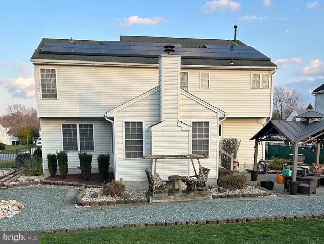 a kitchen with stainless steel appliances granite countertop a sink a stove and a wooden floors