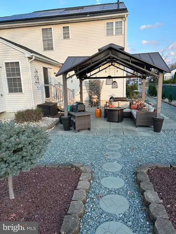 a dining room with furniture a chandelier and wooden floor