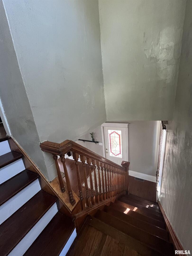 328 East Prospect Street Kewanee, IL 61443 - Photo 22 of 41 a view of staircase with lots of frames on wall and a window