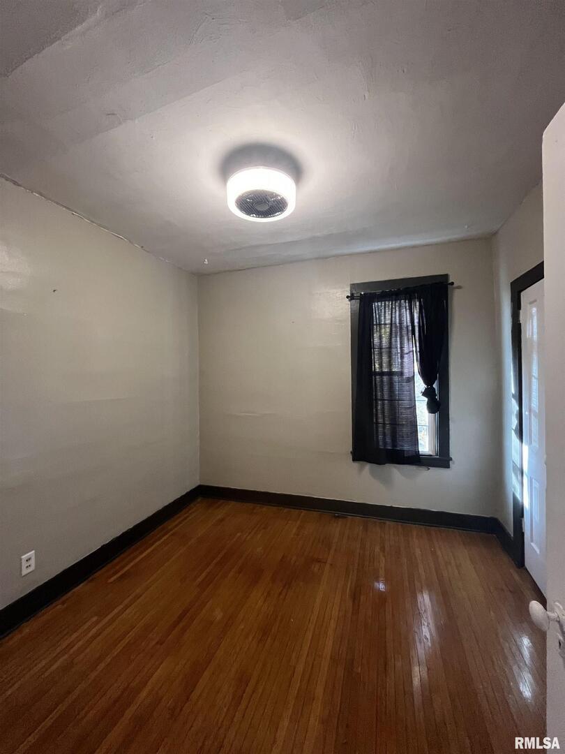 328 East Prospect Street Kewanee, IL 61443 - Photo 24 of 41 a view of an empty room with wooden floor and a window