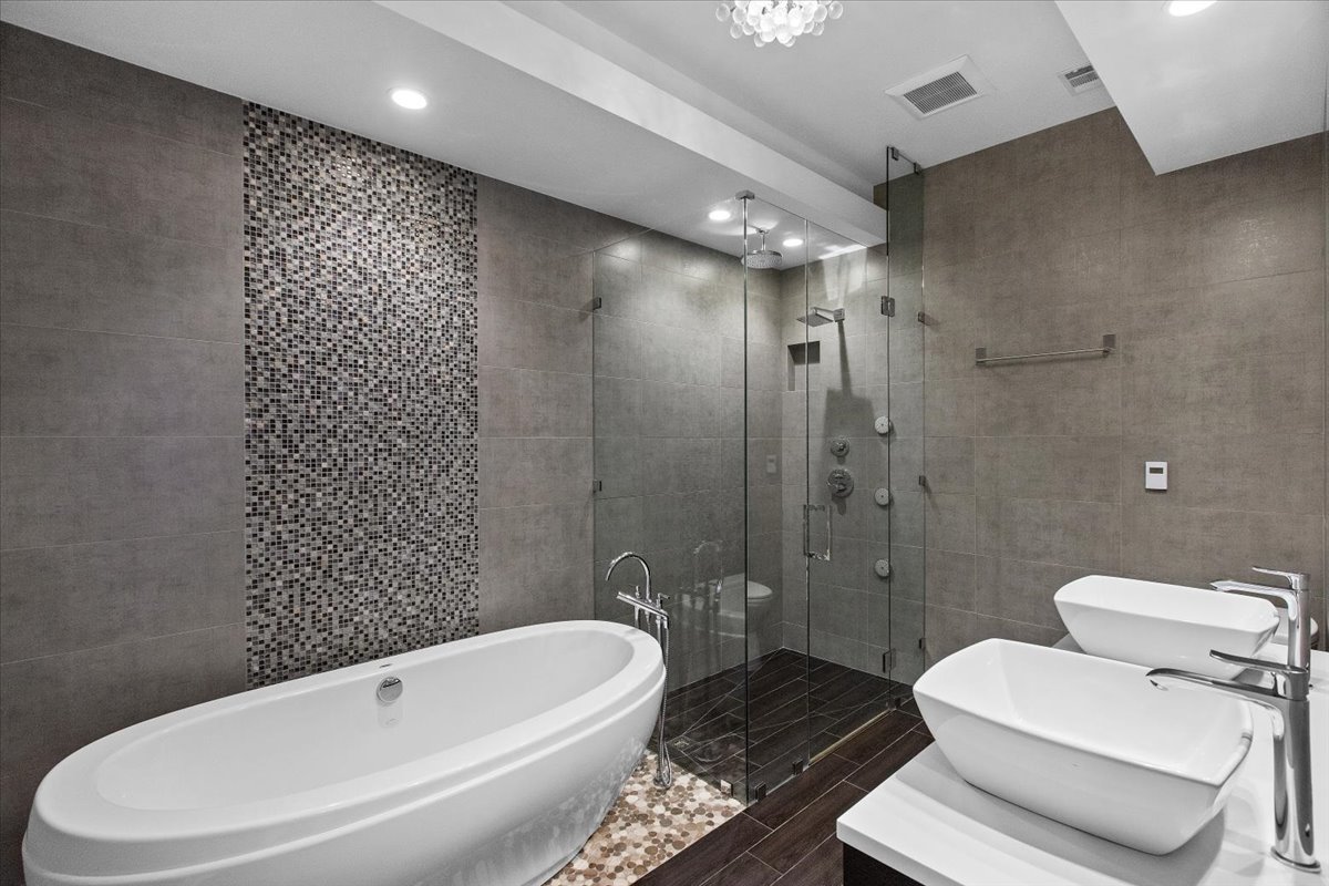 6900 North Sheridan Road, Unit 3E Chicago, IL 60626 - Photo 10 of 10 a white toilet sitting next to a bathroom sink and a shower
