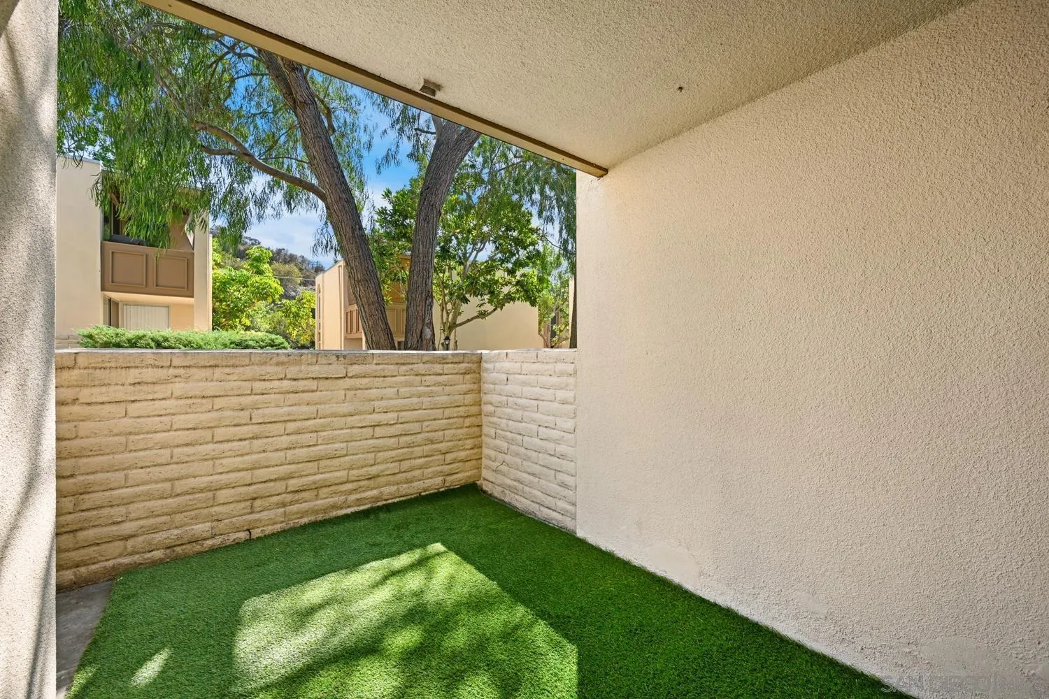 4881 Collwood Boulevard, Unit A San Diego, CA 92115 - Photo 16 of 25 a view of a backyard with a large tree