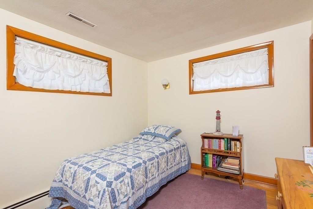 10 Kelch Road Reading, MA 01867 - Photo 12 of 16 a bedroom with a bed and a wall painting