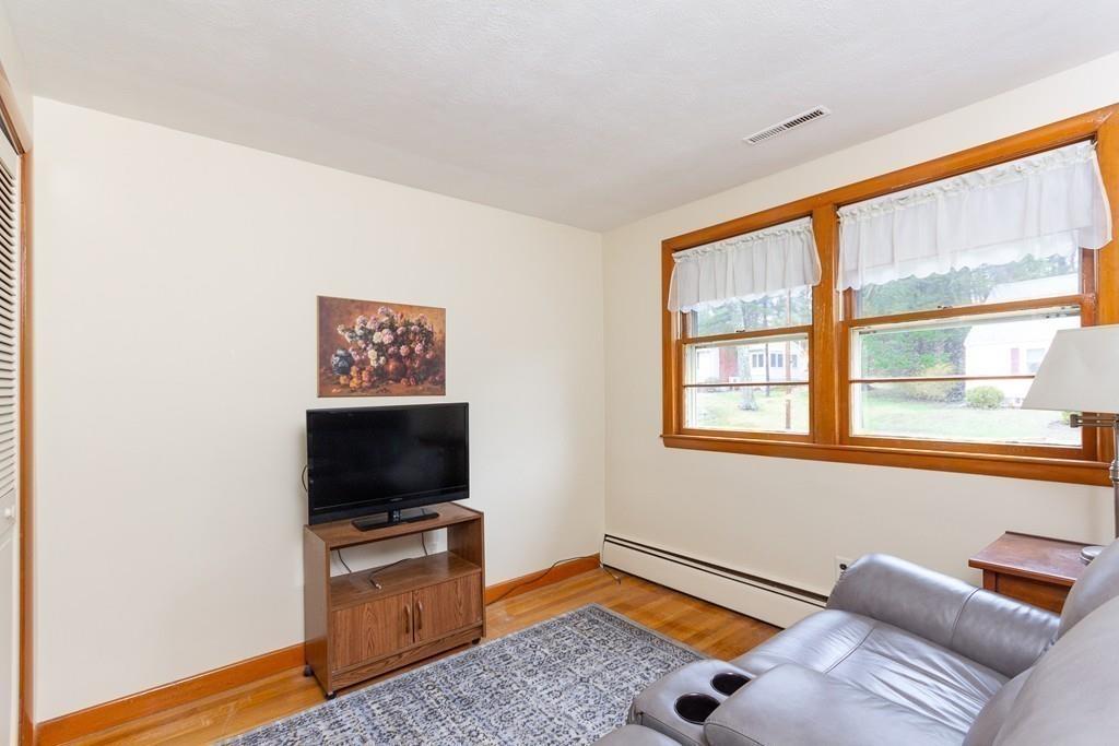 10 Kelch Road Reading, MA 01867 - Photo 14 of 16 a living room with furniture and a flat screen tv