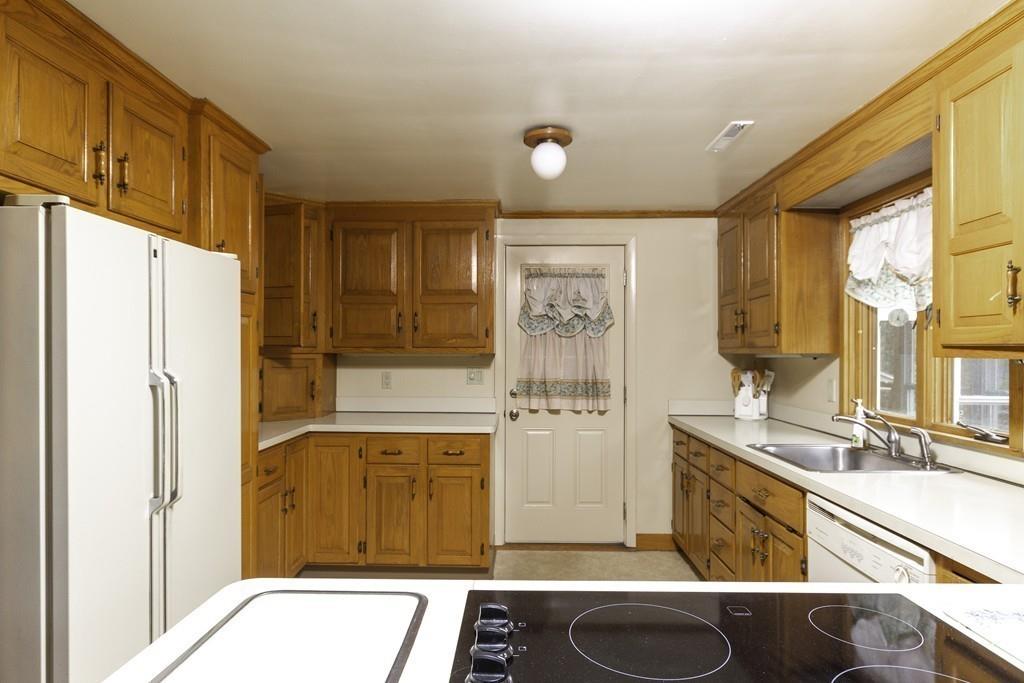 10 Kelch Road Reading, MA 01867 - Photo 7 of 16 a bathroom with a sink a mirror and a bathtub