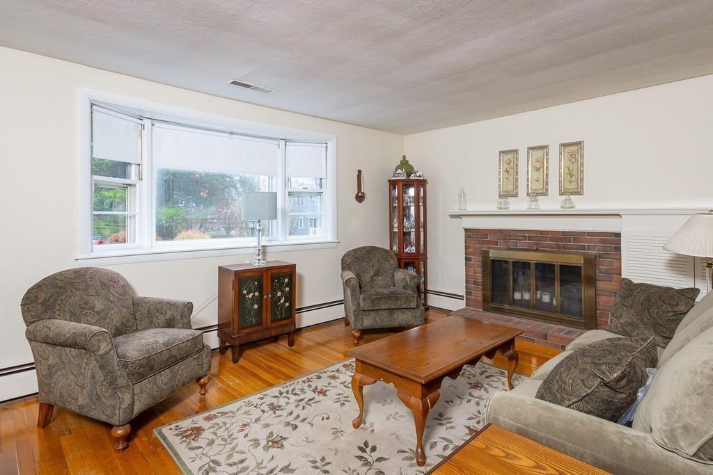 10 Kelch Road Reading, MA 01867 - Photo 10 of 16 a living room with furniture a rug a fireplace and a large window