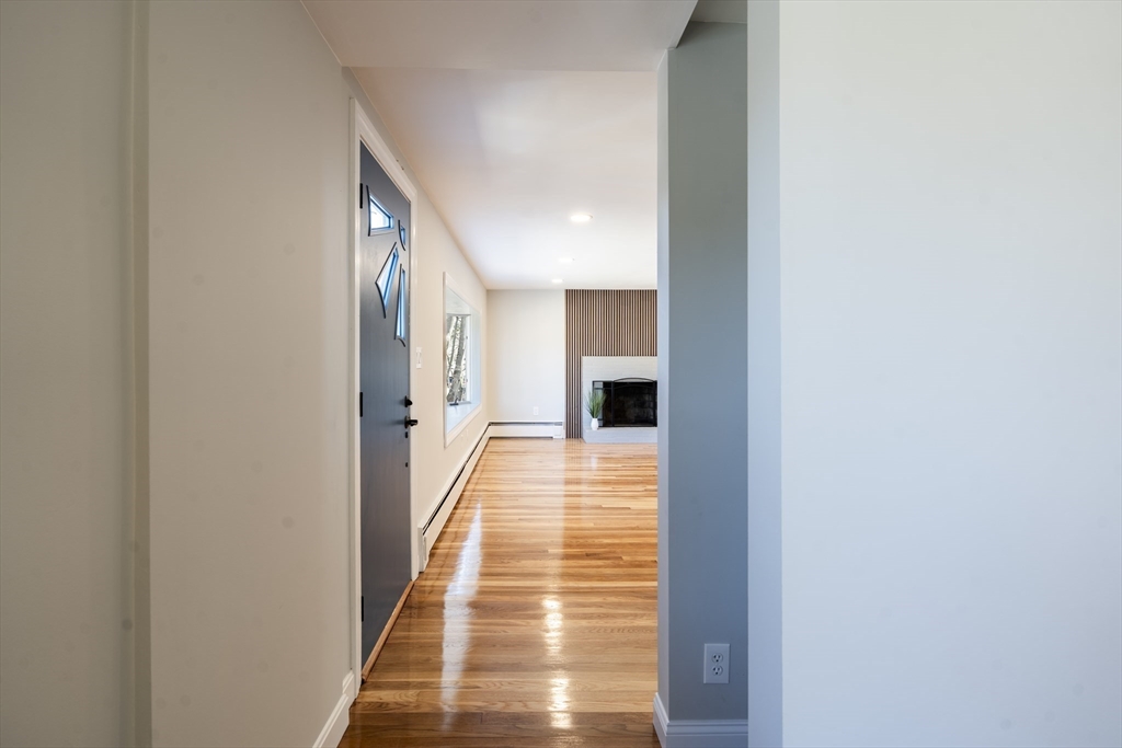 1049 Pleasant Street Canton, MA 02021 - Photo 11 of 34 a view of a hallway with wooden floor and a bathroom
