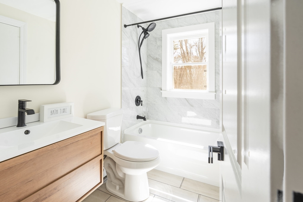 1049 Pleasant Street Canton, MA 02021 - Photo 14 of 34 a bathroom with a sink a toilet and shower