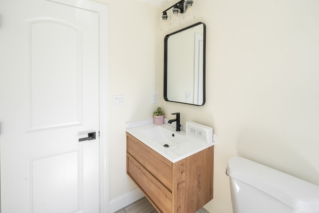 1049 Pleasant Street Canton, MA 02021 - Photo 15 of 34 a bathroom with a sink a toilet and mirror