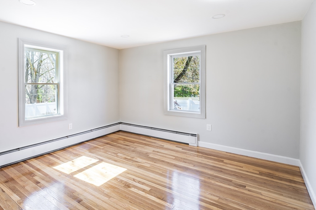 1049 Pleasant Street Canton, MA 02021 - Photo 16 of 34 a view of an empty room with wooden floor and a window