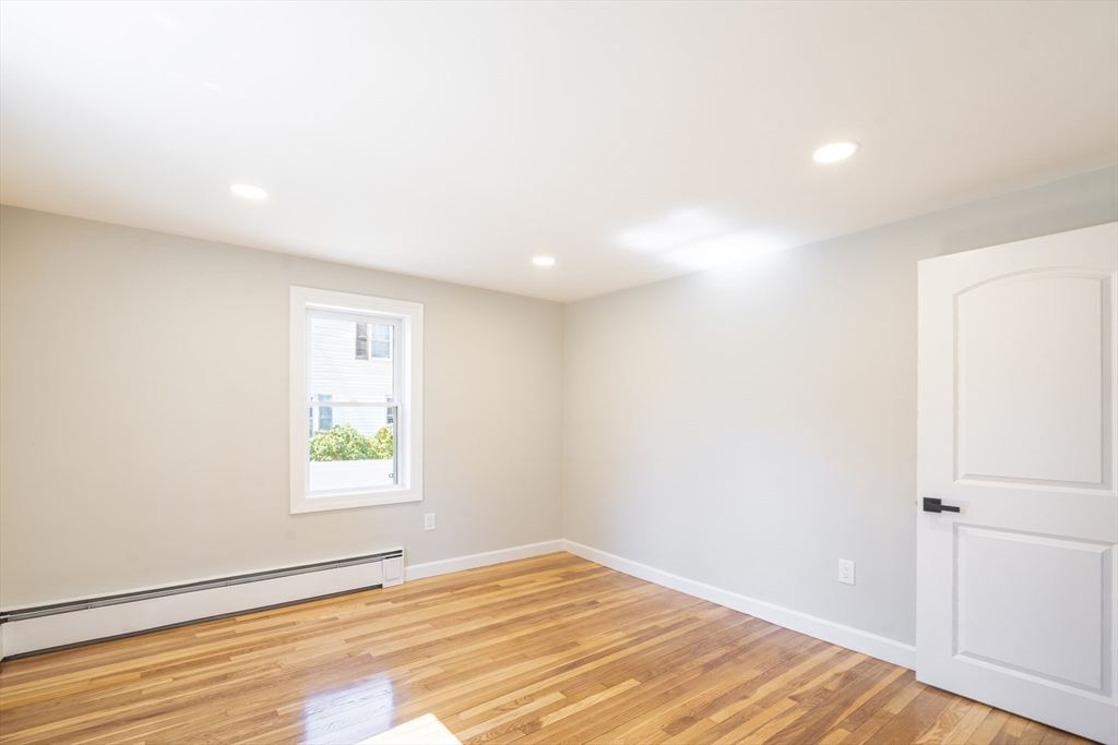 1049 Pleasant Street Canton, MA 02021 - Photo 17 of 34 an empty room with wooden floor and windows
