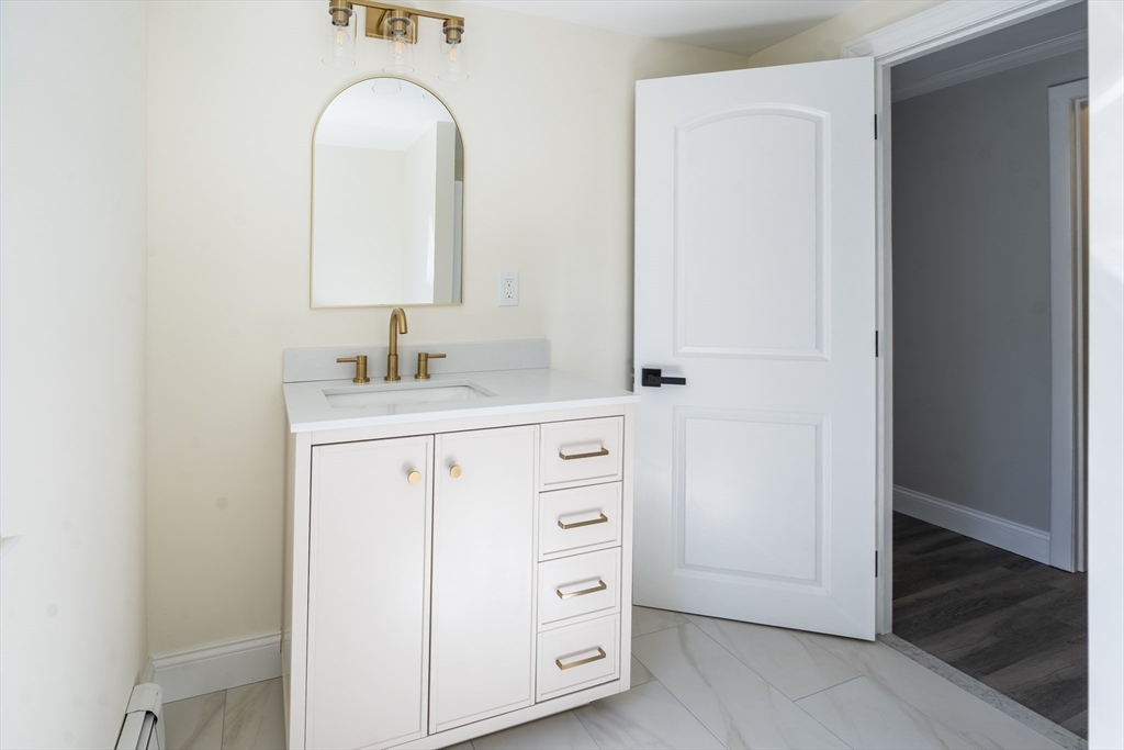 1049 Pleasant Street Canton, MA 02021 - Photo 19 of 34 a bathroom with a sink vanity and a mirror