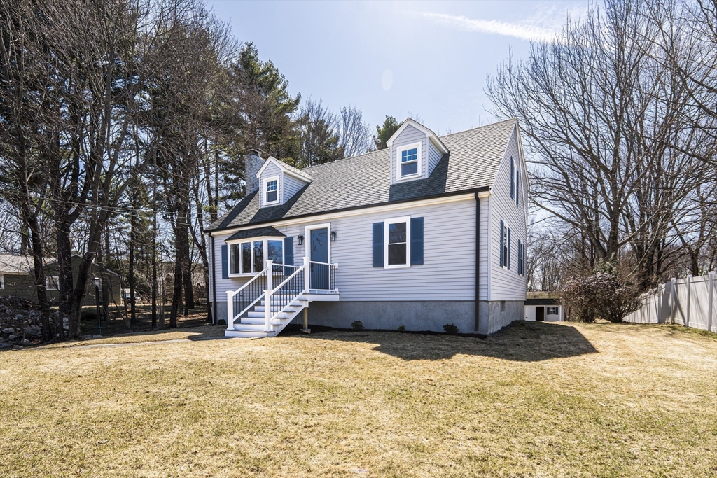 1049 Pleasant Street Canton, MA 02021 - Photo 2 of 34 a view of a white house with a yard covered with snow in the yard