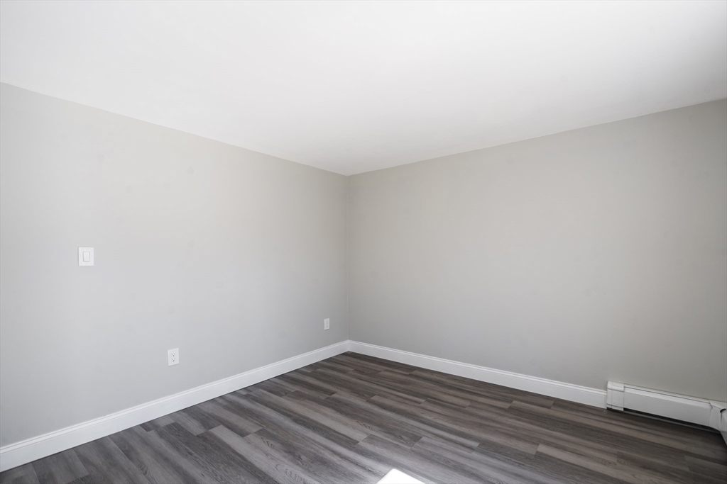 1049 Pleasant Street Canton, MA 02021 - Photo 22 of 34 a view of an empty room with wooden floor