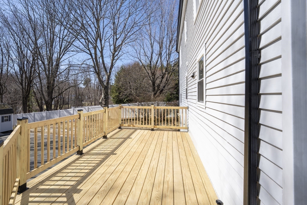 1049 Pleasant Street Canton, MA 02021 - Photo 30 of 34 a view of balcony with wooden floor and fence and trees