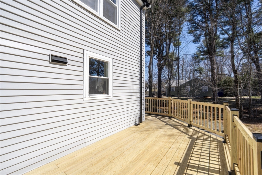 1049 Pleasant Street Canton, MA 02021 - Photo 31 of 34 a view of a deck with a large window and wooden floor