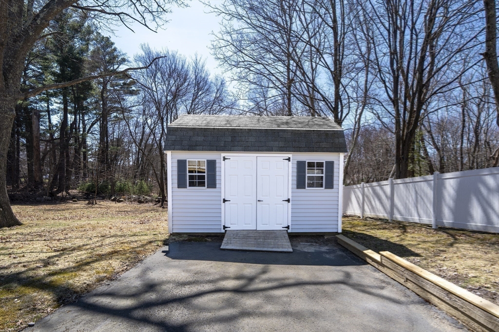 1049 Pleasant Street Canton, MA 02021 - Photo 33 of 34 a view of a house with a yard covered in snow